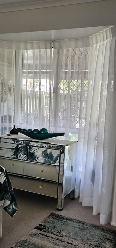 A Bedroom With a Bed and a Window With White Curtains — Artizen Curtains in Mooloolaba, QLD