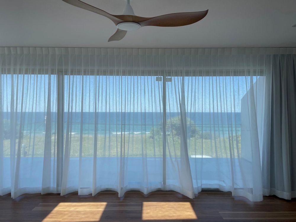 A Room with A Ceiling Fan and A View of The Ocean — Artizen Curtains in Mooloolaba, QLD