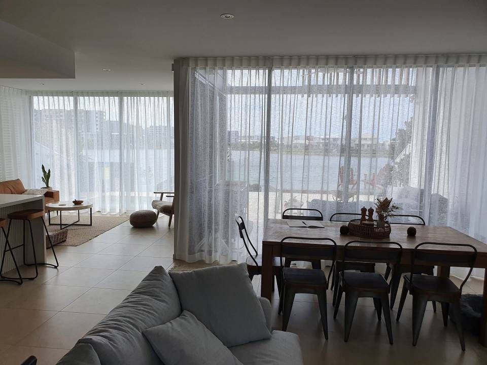 A Living Room With a Couch, Table, Chairs and Curtains — Artizen Curtains in Mooloolaba, QLD