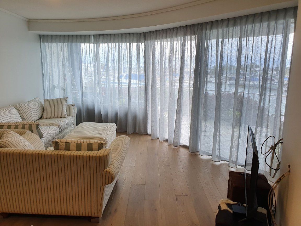 A Living Room With a Couch, Television, and Curtains — Artizen Curtains in Mooloolaba, QLD