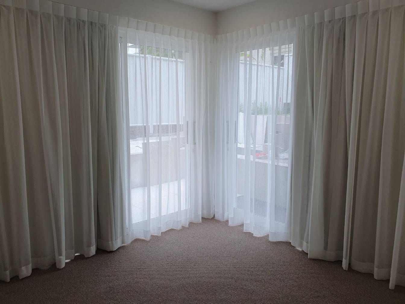 An Empty Room With White Curtains and a Balcony — Artizen Curtains in Mooloolaba, QLD