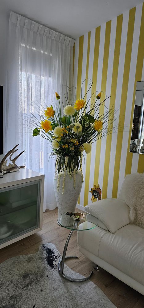 A Living Room With a Couch and a Vase of Flowers on a Table — Artizen Curtains in Mooloolaba, QLD