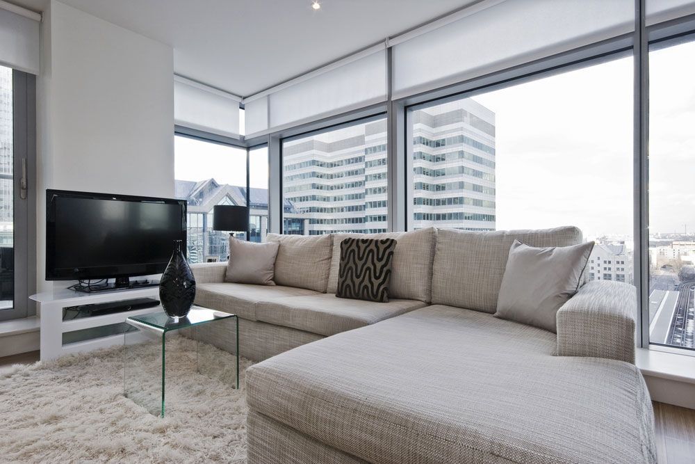 A Living Room With a Couch and a Flat Screen TV — Artizen Curtains in Mooloolaba, QLD