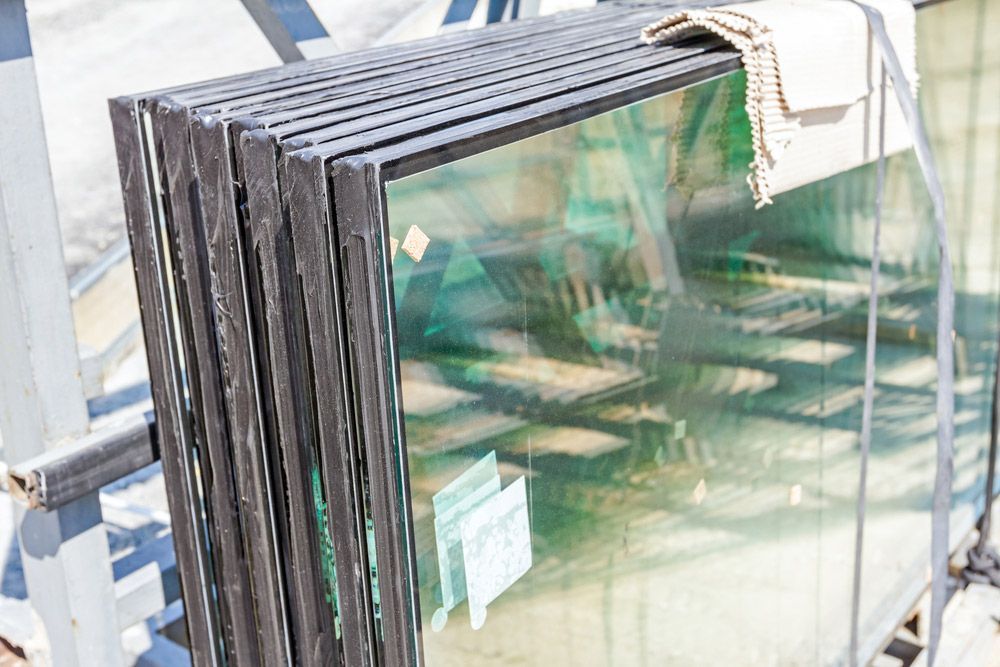 A Stack of Glass Sitting on Top of Each Other on a Shelf — Artizen Curtains in Mooloolaba, QLD