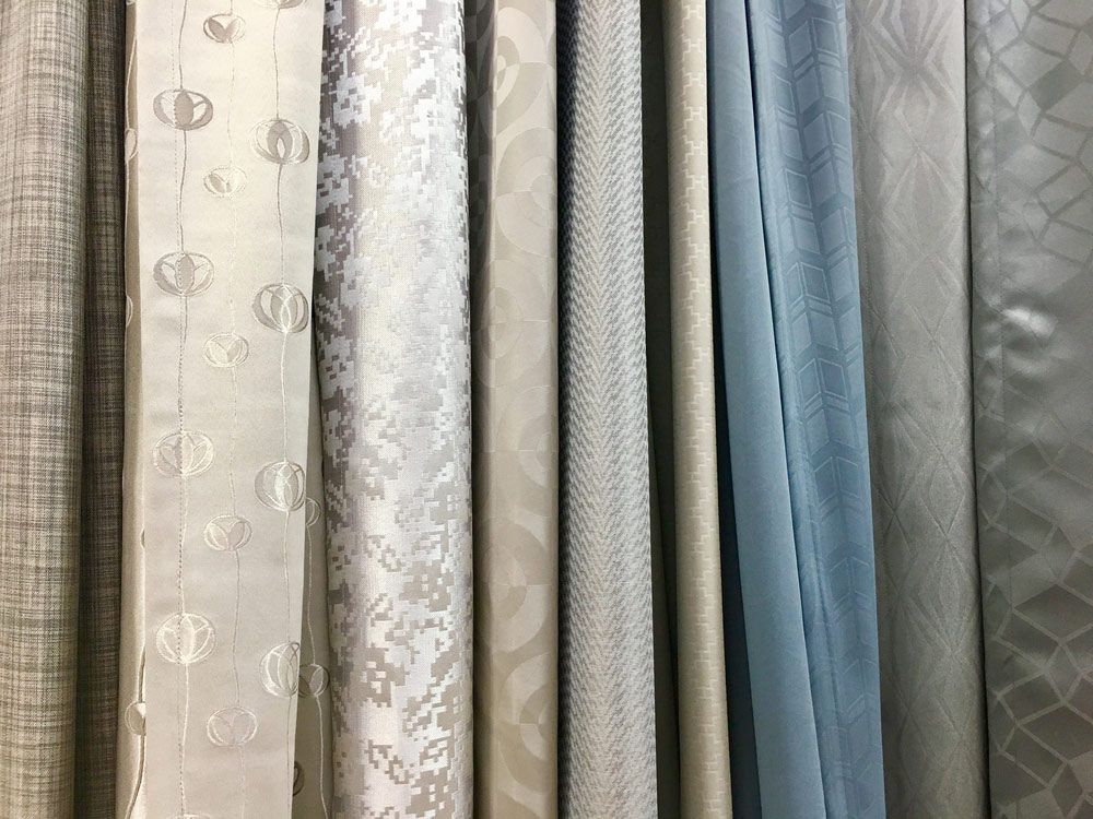 A Row of Curtains Hanging on a Wall in a Store — Artizen Curtains in Coolum, QLD