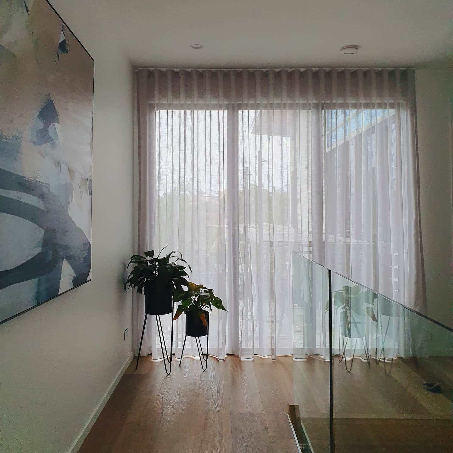 A Room With a Staircase and a Painting on the Wall — Artizen Curtains in Mooloolaba, QLD