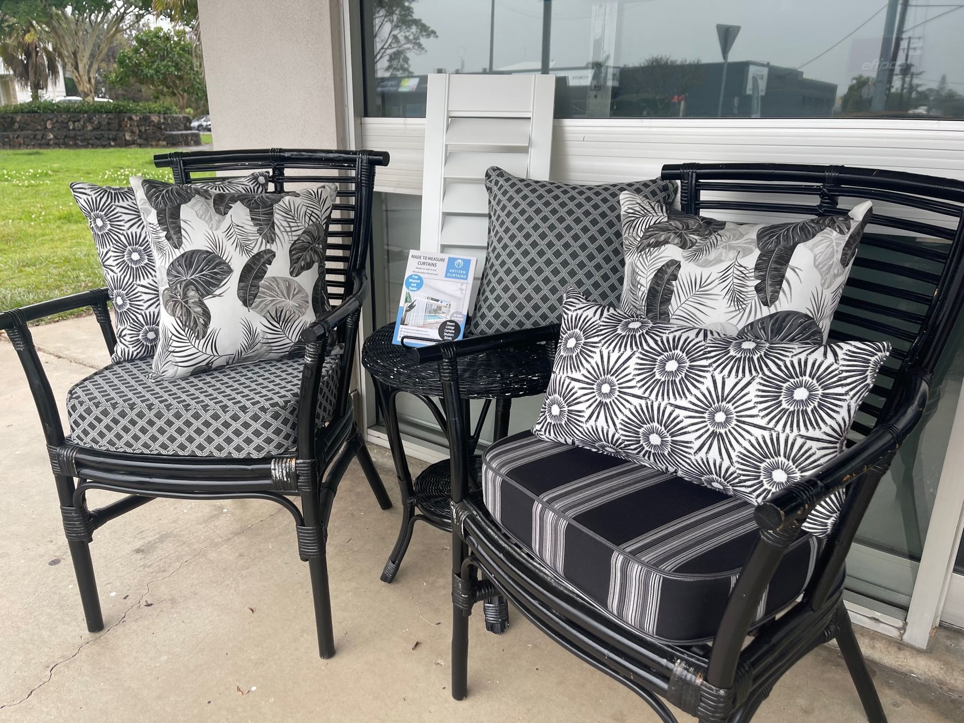 Two Chairs and A Table Are Sitting on A Patio in Front of A Window — Artizen Curtains in Mooloolaba, QLD