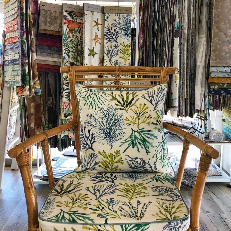 A Chair with A Pillow on It in A Store — Artizen Curtains in Noosa, QLD