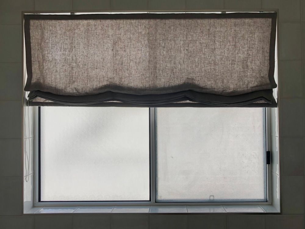 A Window with A Blind on It and A Sliding Glass Door — Artizen Curtains in Maroochydore, QLD