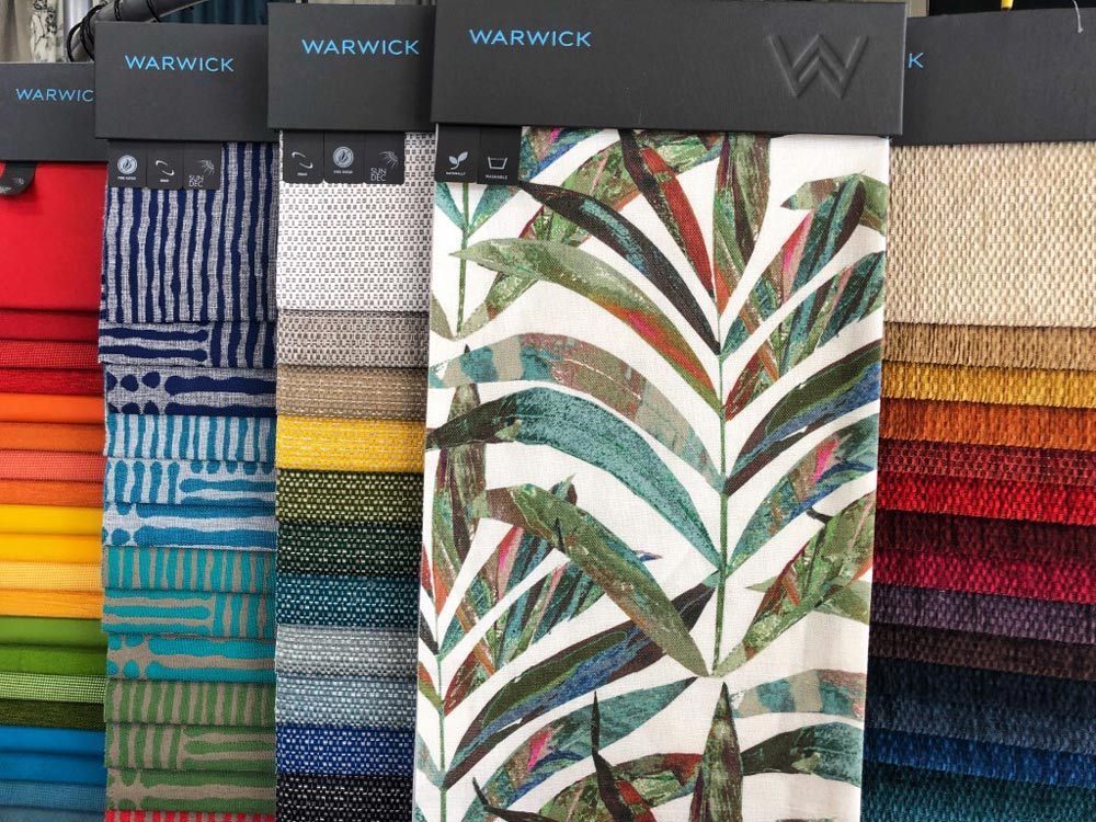 A Variety of Fabrics Are Displayed in a Store — Artizen Curtains in Mooloolaba, QLD