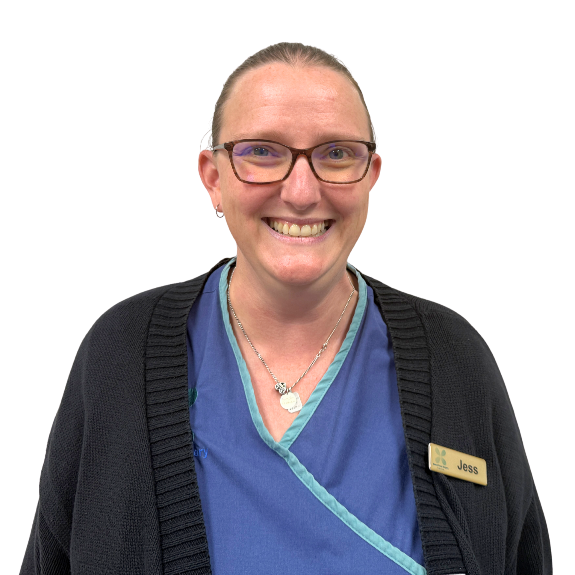 A woman in a blue scrub top is smiling for the camera.
