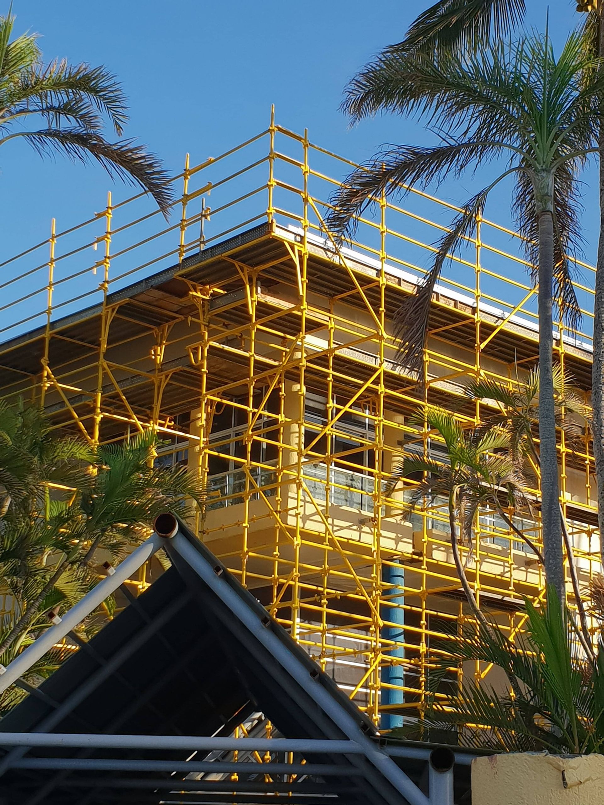 Yellow Scaffolding On Large Home — Airlie Action Scaffolding gallery in Arlie Beach, QLD