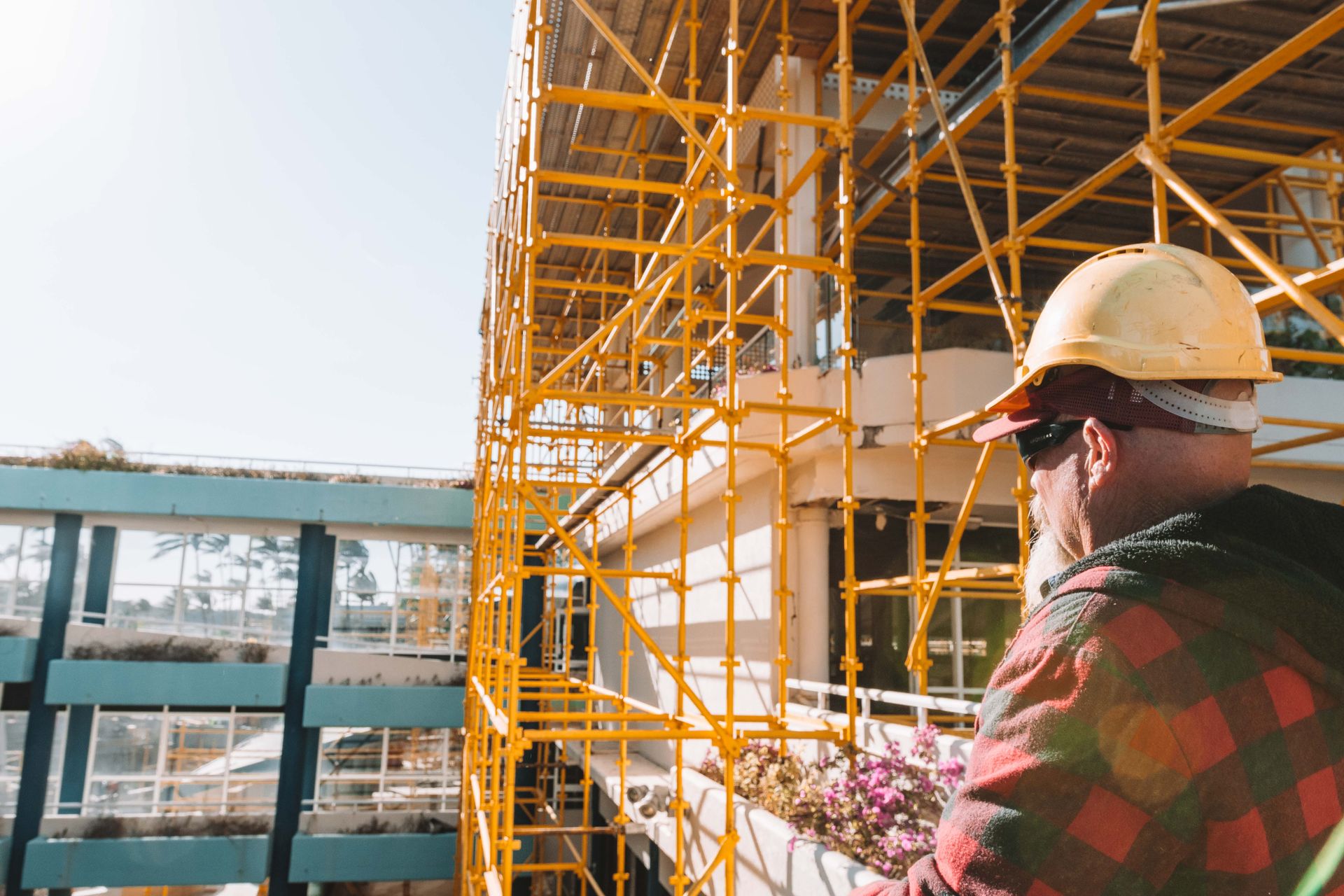 Tradie Sitting On Scaffolding Looking At View — Airlie Action Scaffolding gallery in Arlie Beach, QLD