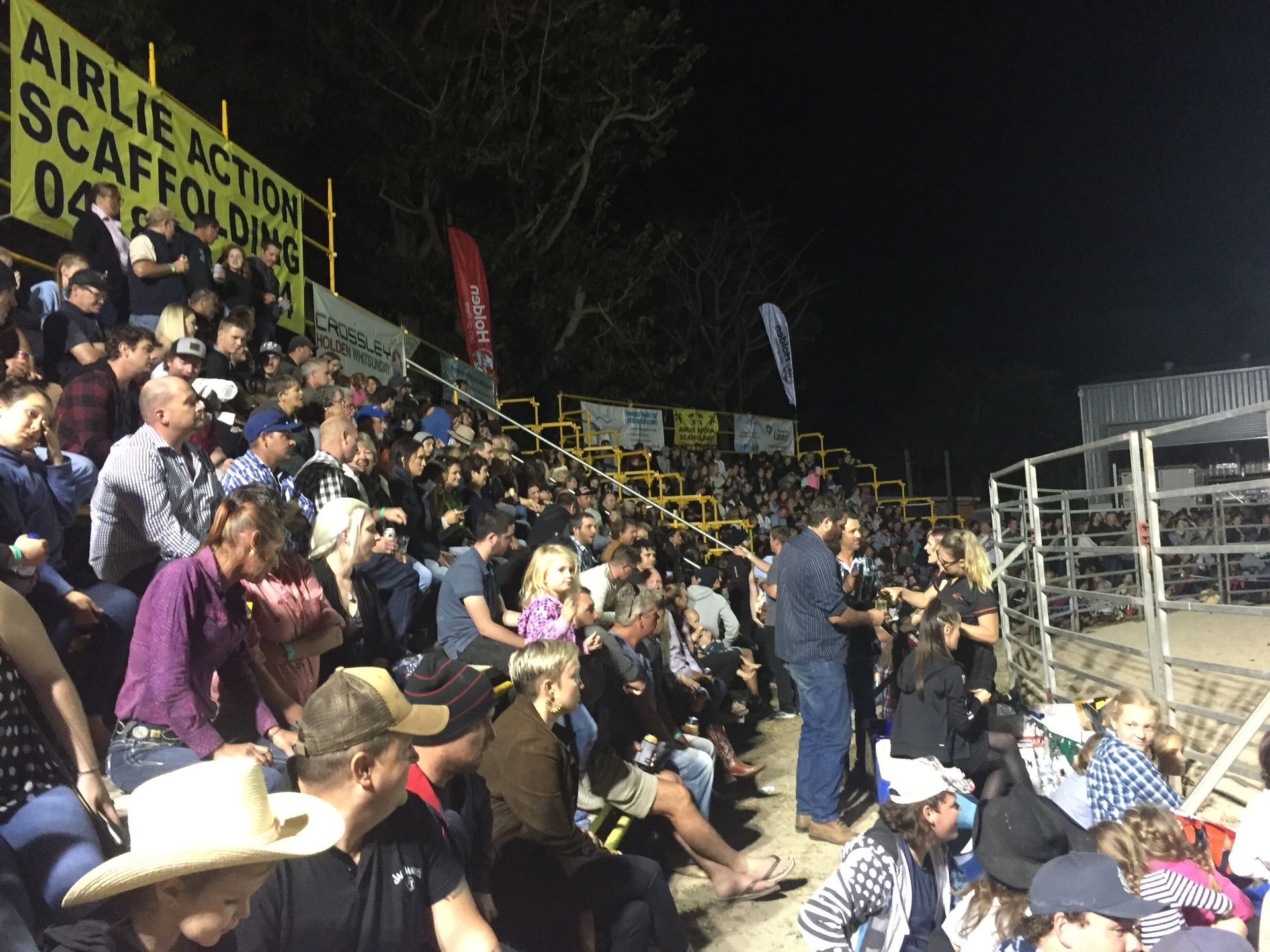 Large Audience Sitting On Yellow Grandstand — Airlie Action Scaffolding gallery in Arlie Beach, QLD