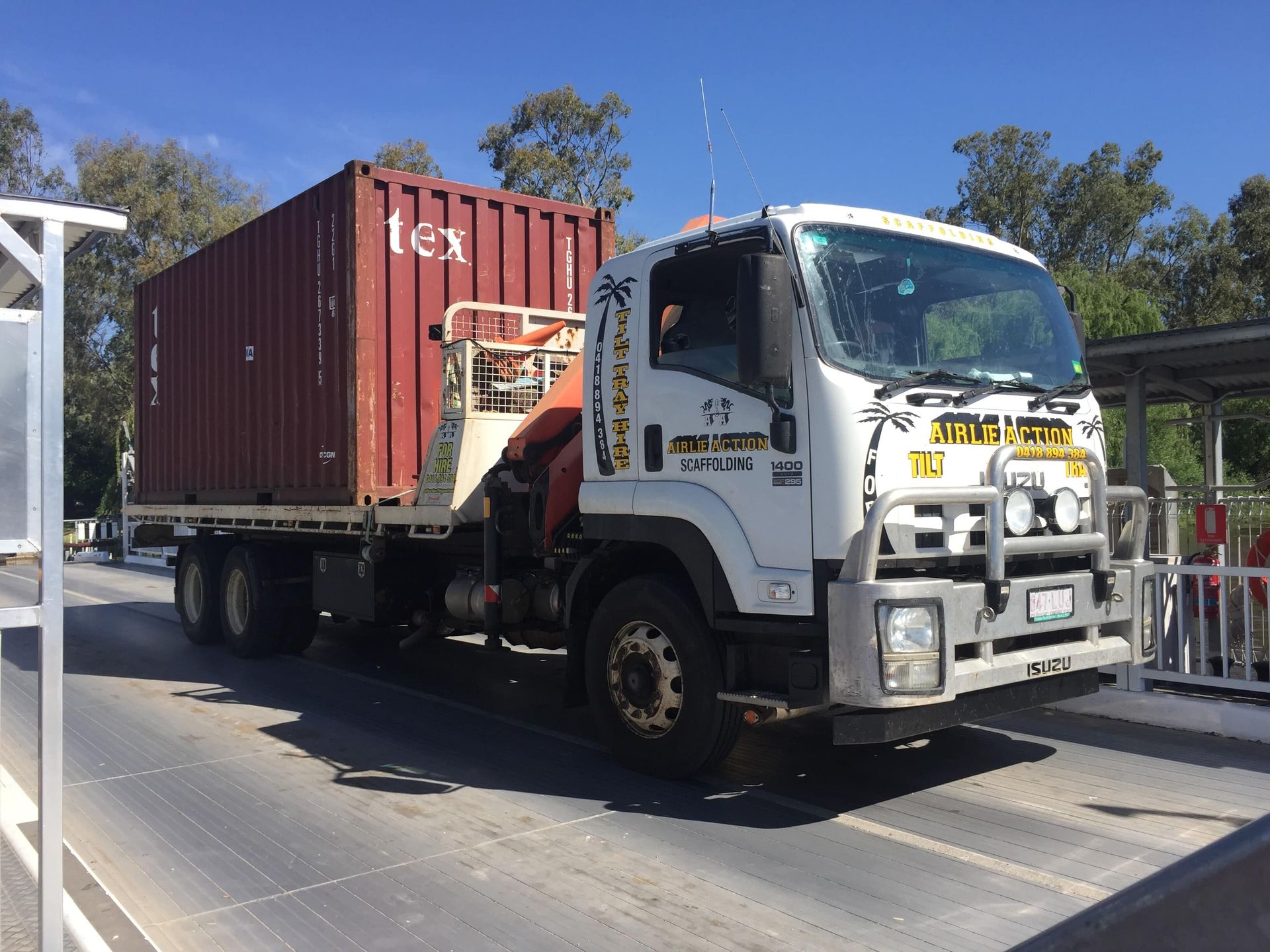 HIAB Truck Carrying Red Container— Tilt tray hire Whitsundays in Arlie Beach, QLD