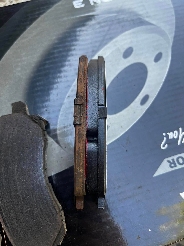 A Pair Of Brake Pads Are Sitting On Top Of A Box — MJ's Mobile Car Mechanic In Dapto, NSW