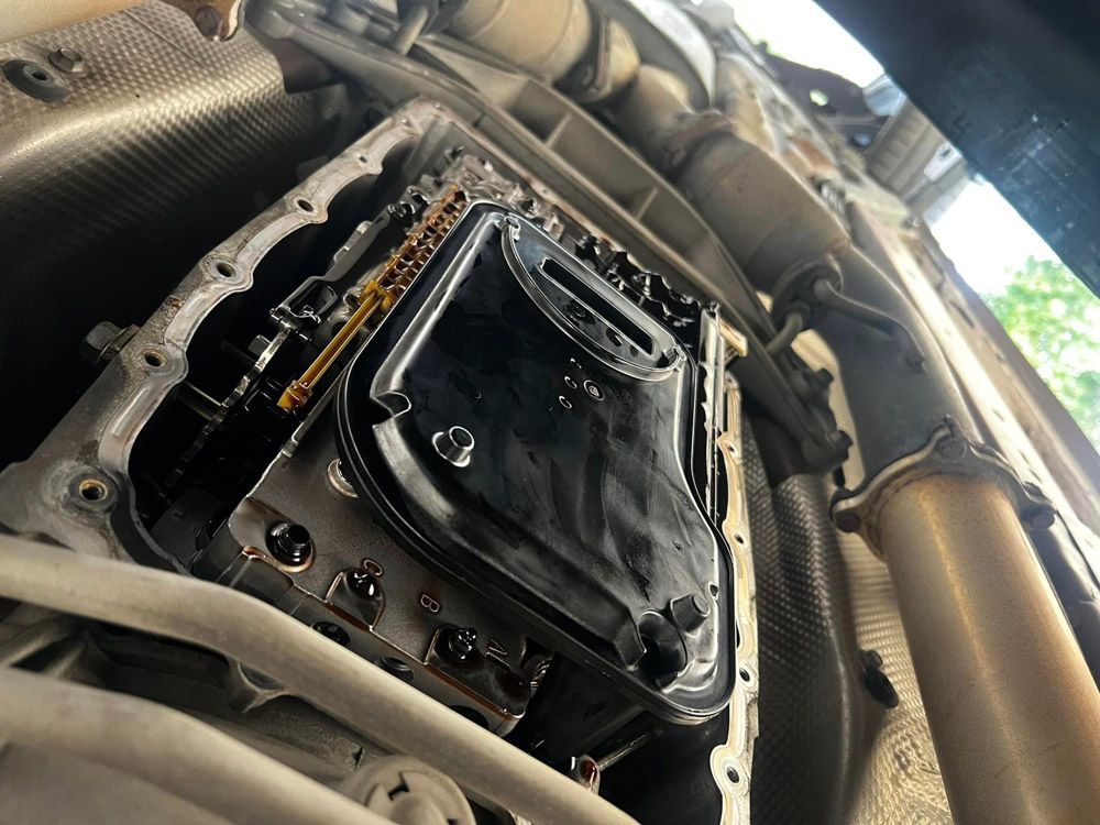 A Close Up Of A Car Engine With The Oil Pan Removed — MJ's Mobile Car Mechanic In Dapto, NSW