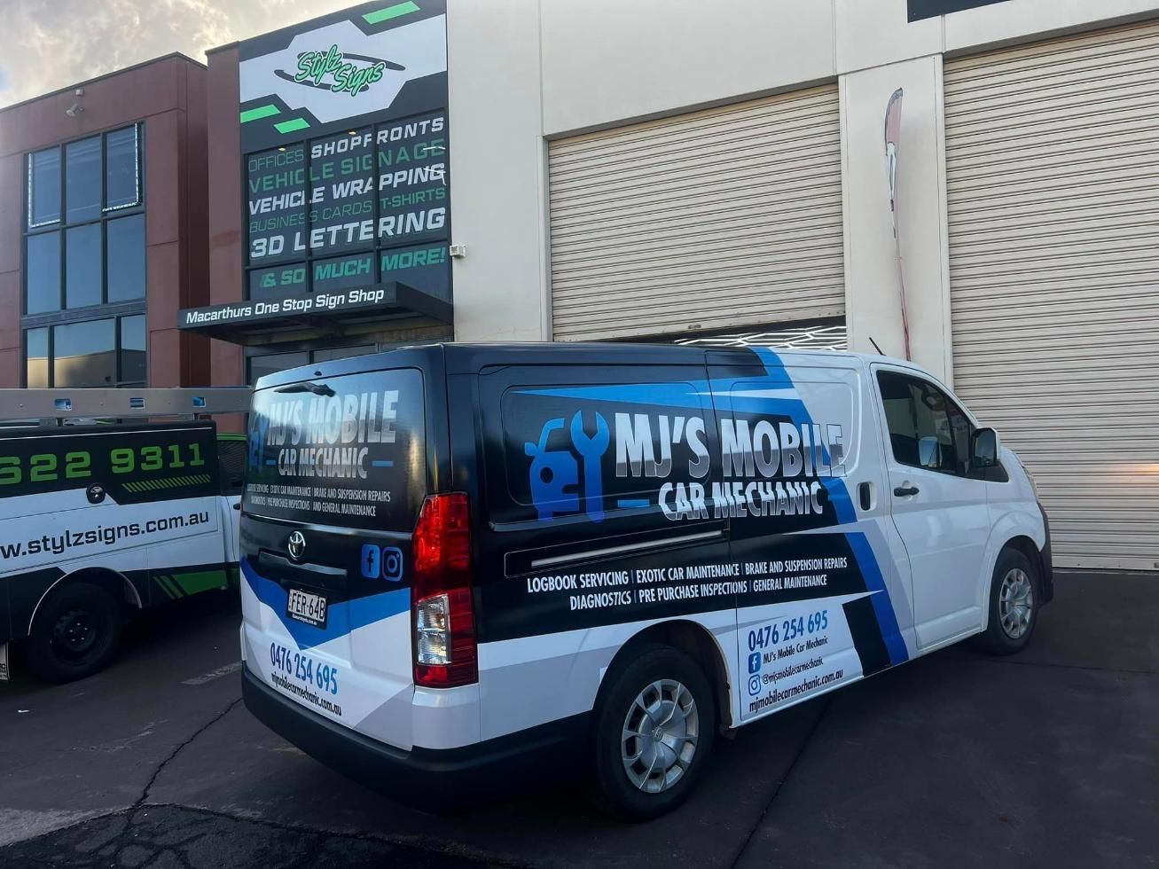 A White Van Is Parked In Front Of A Building — MJ's Mobile Car Mechanic In Thirroul, NSW