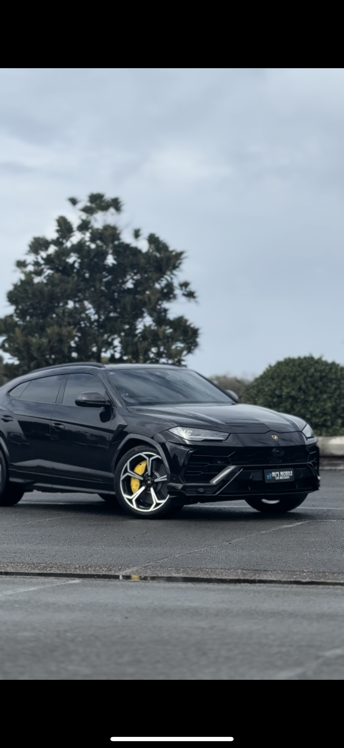 Black Lamborghini Urus SUV with gold wheels parked on asphalt  — MJ's Mobile Car Mechanic In Burleigh Heads, QLD