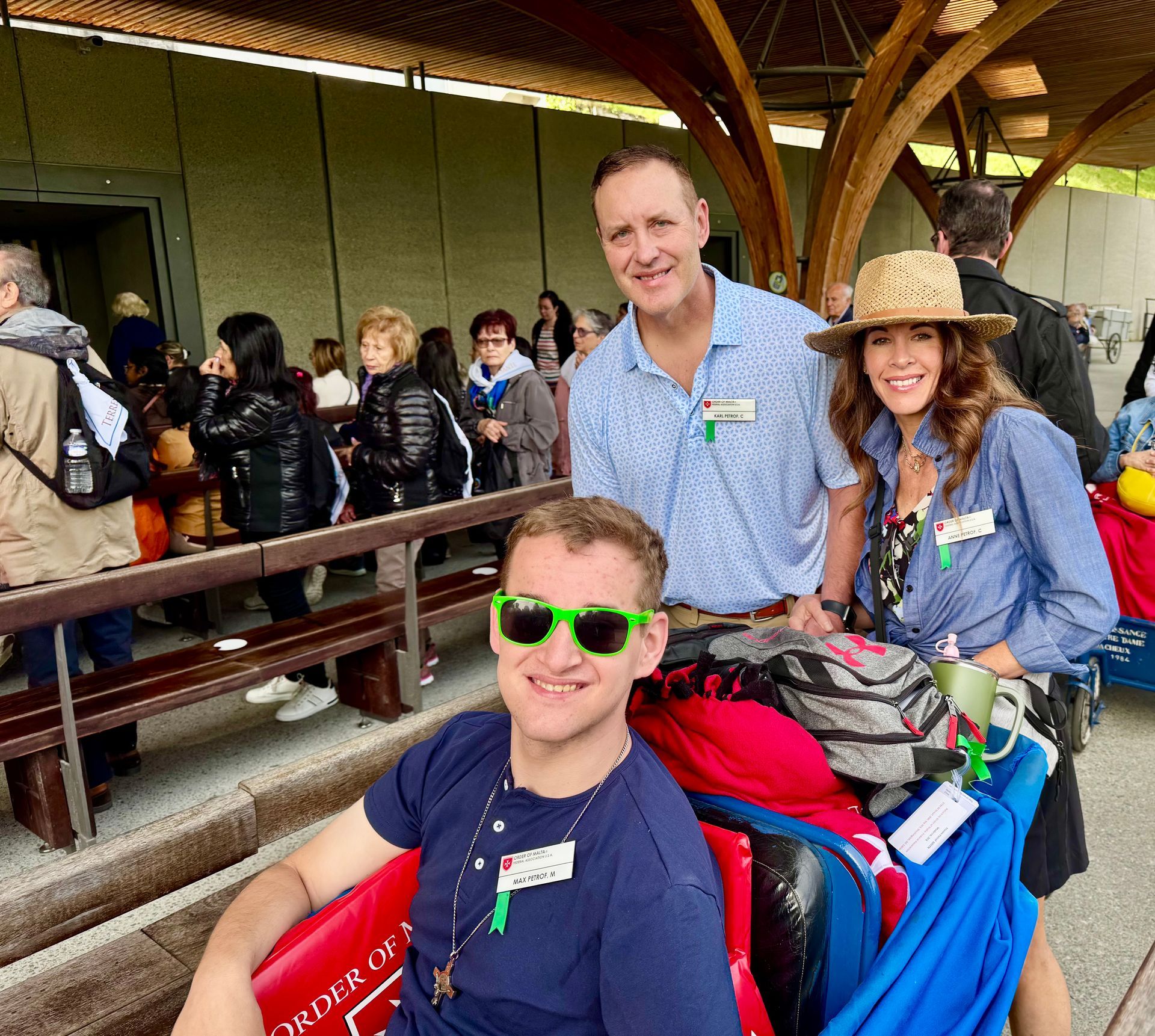 Two boys wearing birthday hats are sitting next to each other in a kitchen.