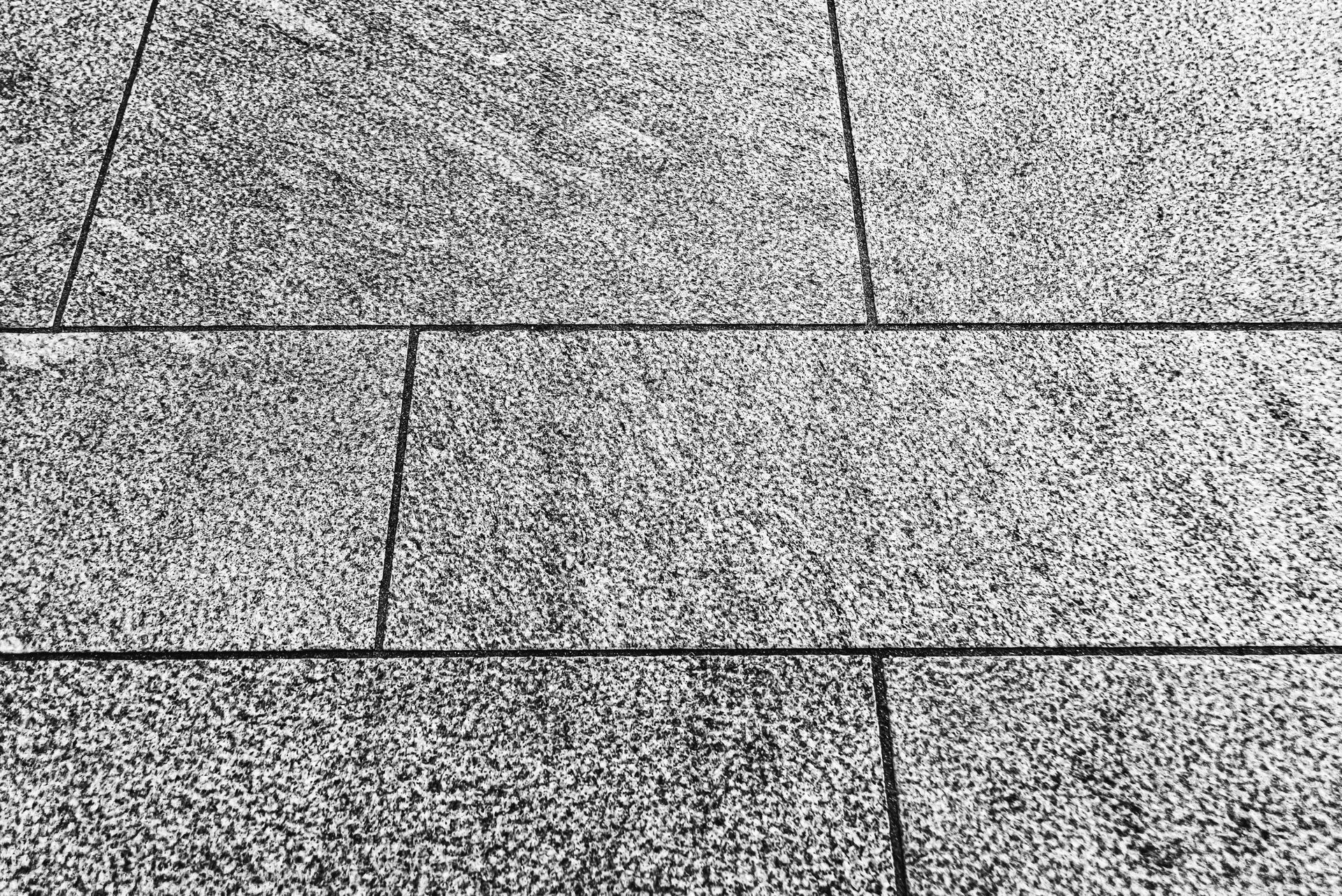 A black and white photo of a tiled floor.