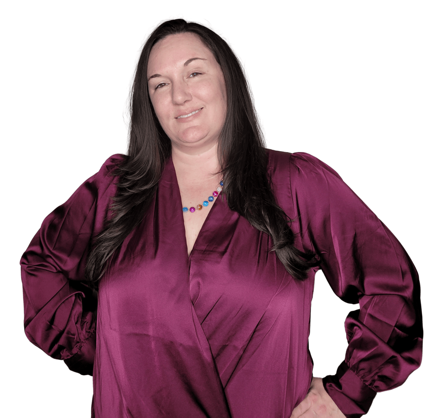 Woman in burgundy satin shirt, hands on hips, smiling, against a white background is Christina Binns, Realtor.