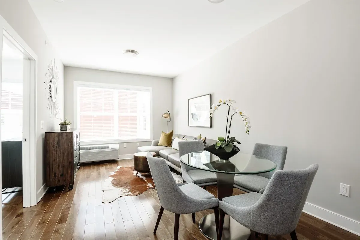 A living room with a dining table and chairs