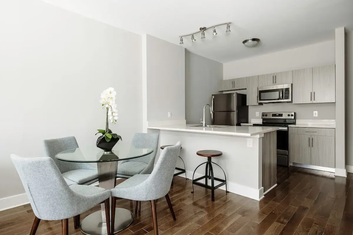 A kitchen with a table and chairs in it