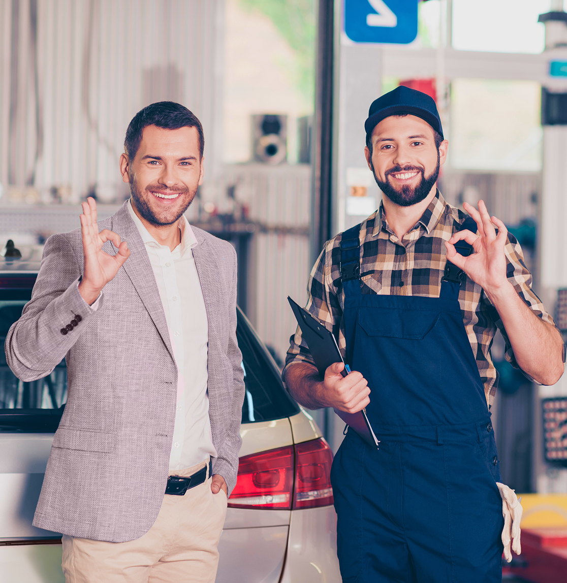 Man and mechanic smiling, giving 