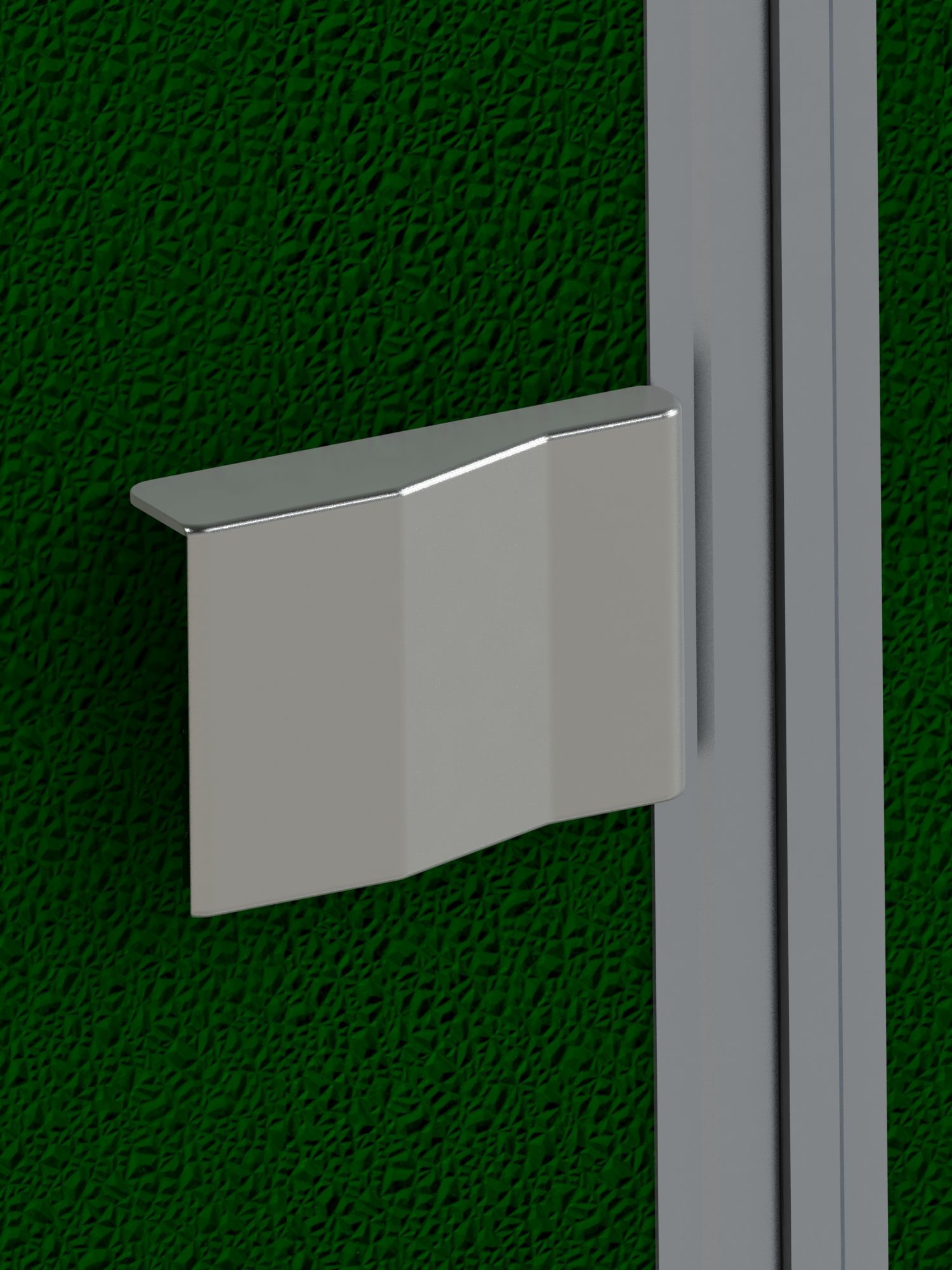 A close up of a metal handle on a green wall.