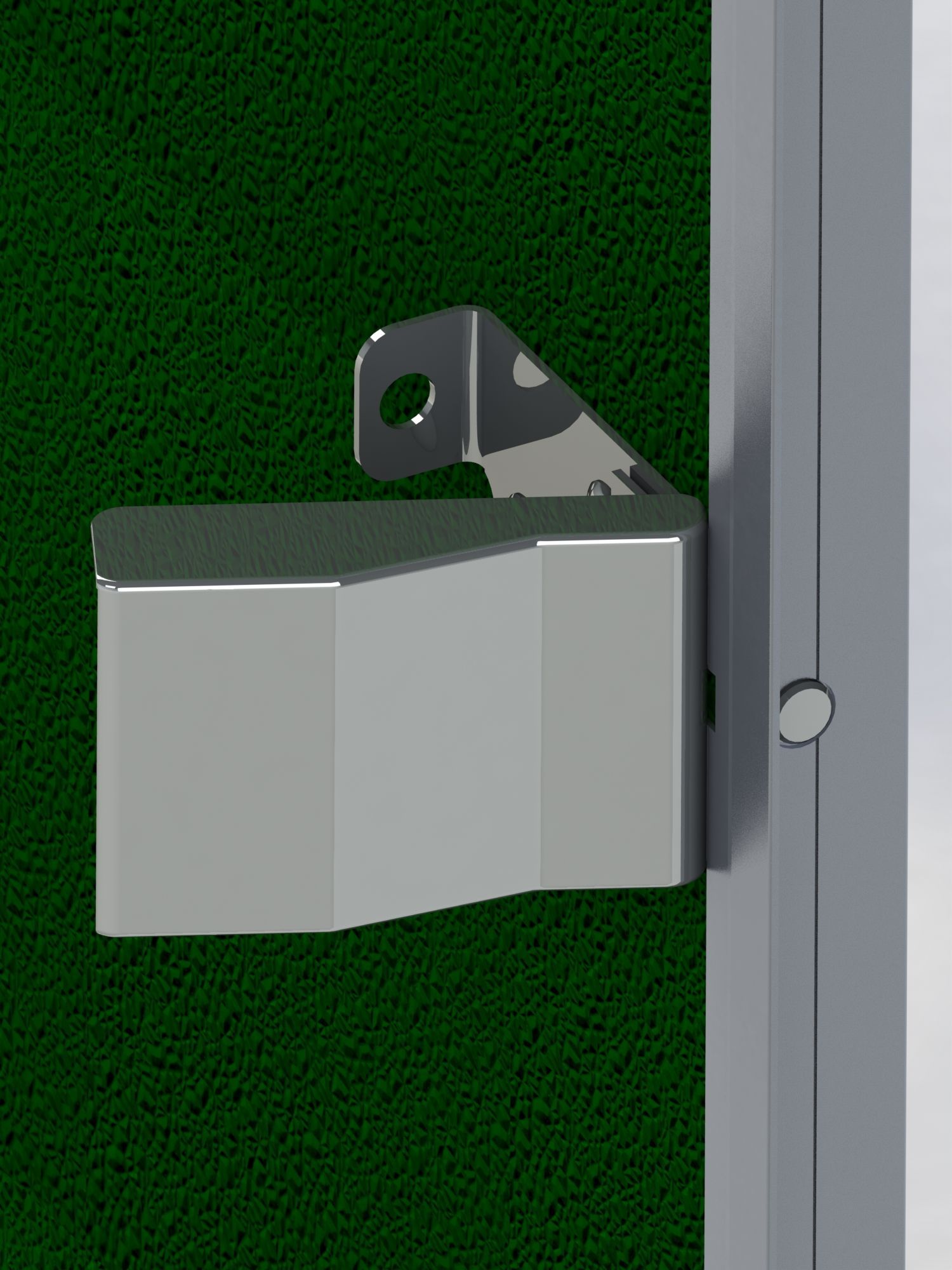 A metal object is attached to a green wall.