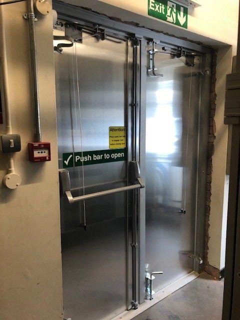 A silver emergency exit door