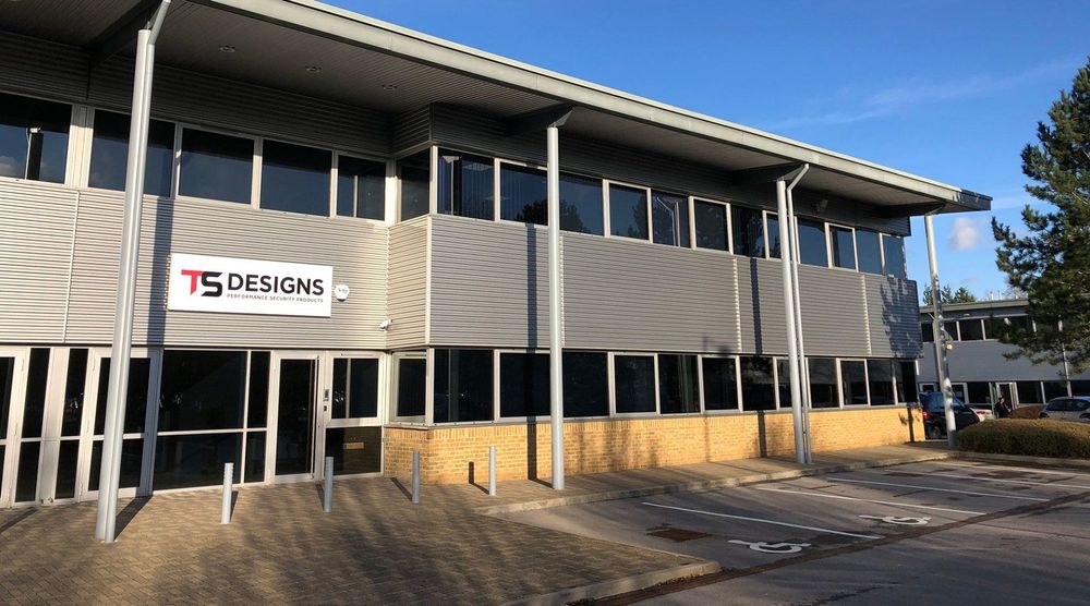 A large building with a sign that says ts designs on it