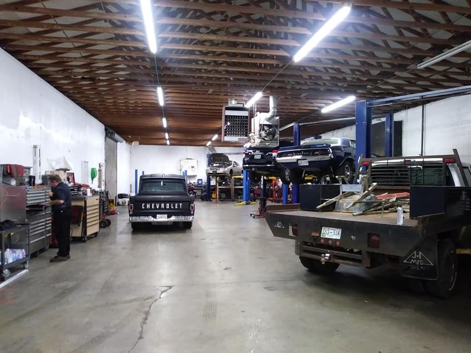 A man is working on a truck in a garage