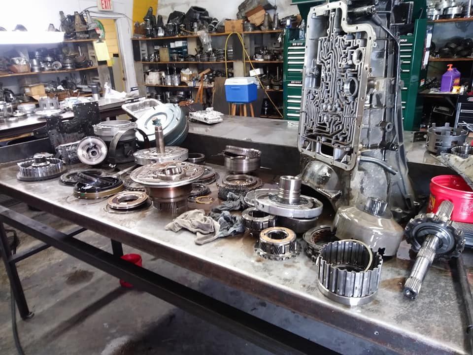A table with a lot of parts on it in a garage