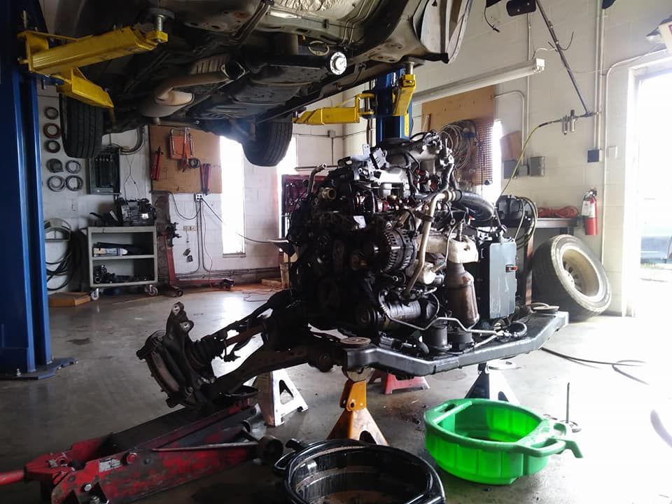 A car engine is being worked on in a garage.