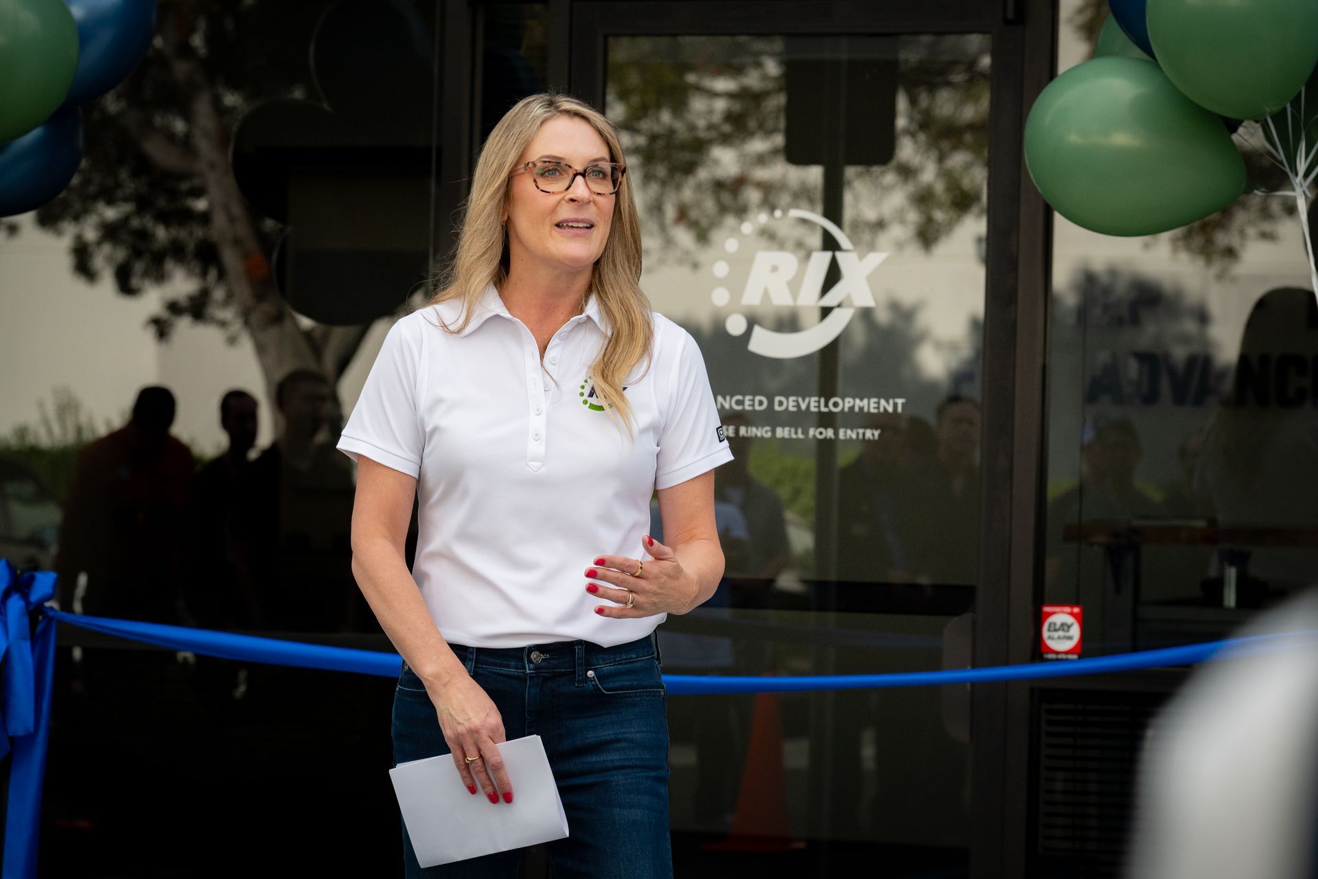 Woman presents in front of ribbon cutting ceremony