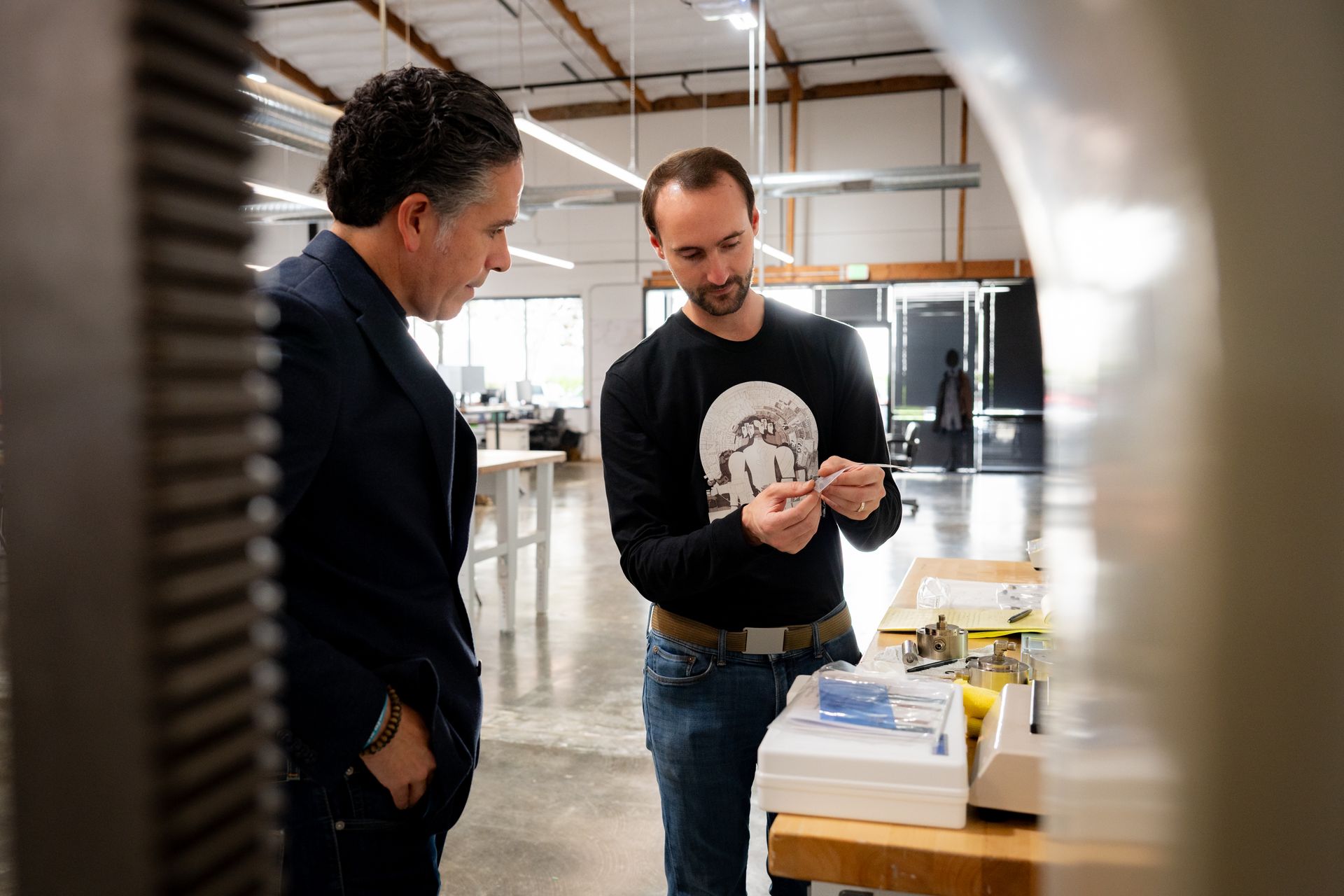 One man shows technology piece to another man