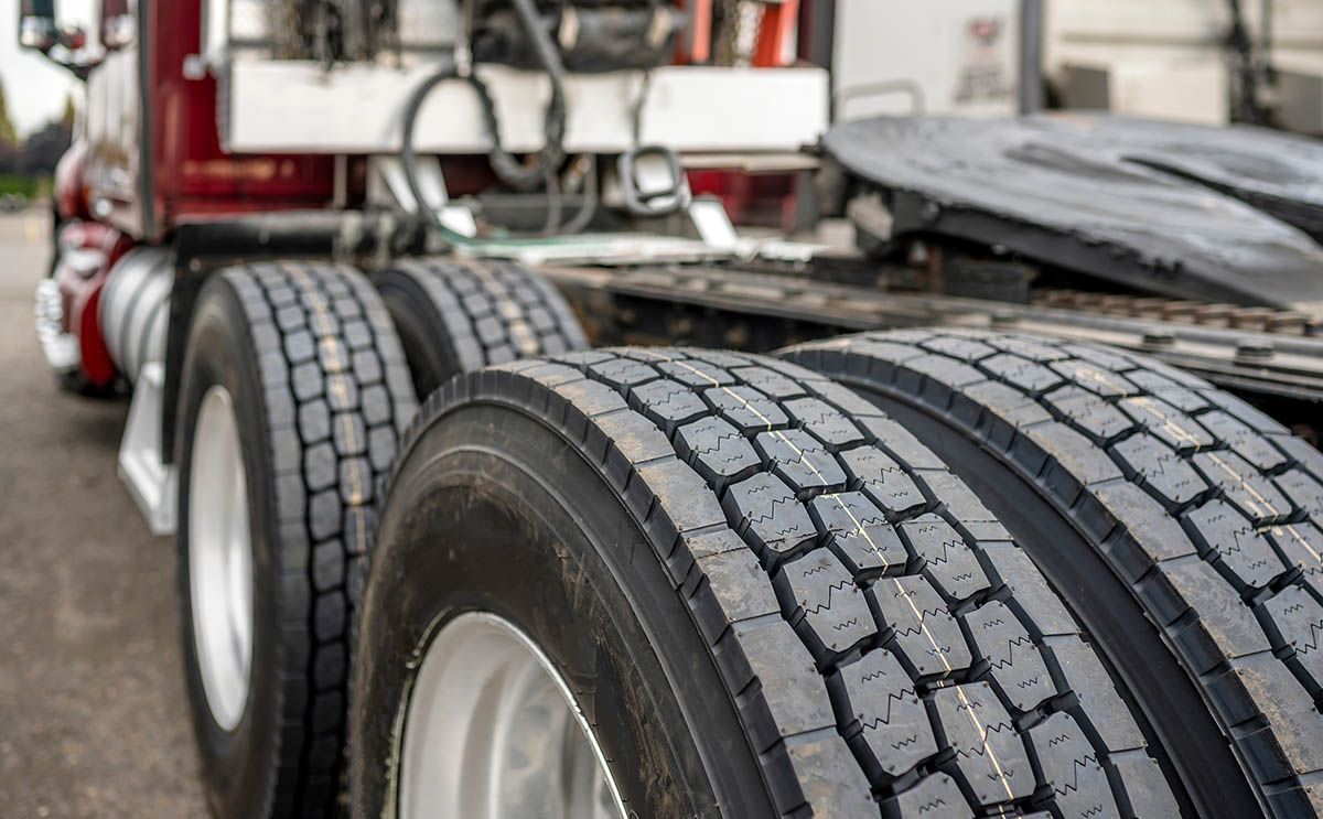 Photo close up of large tires on 18 wheeler commercial truck 