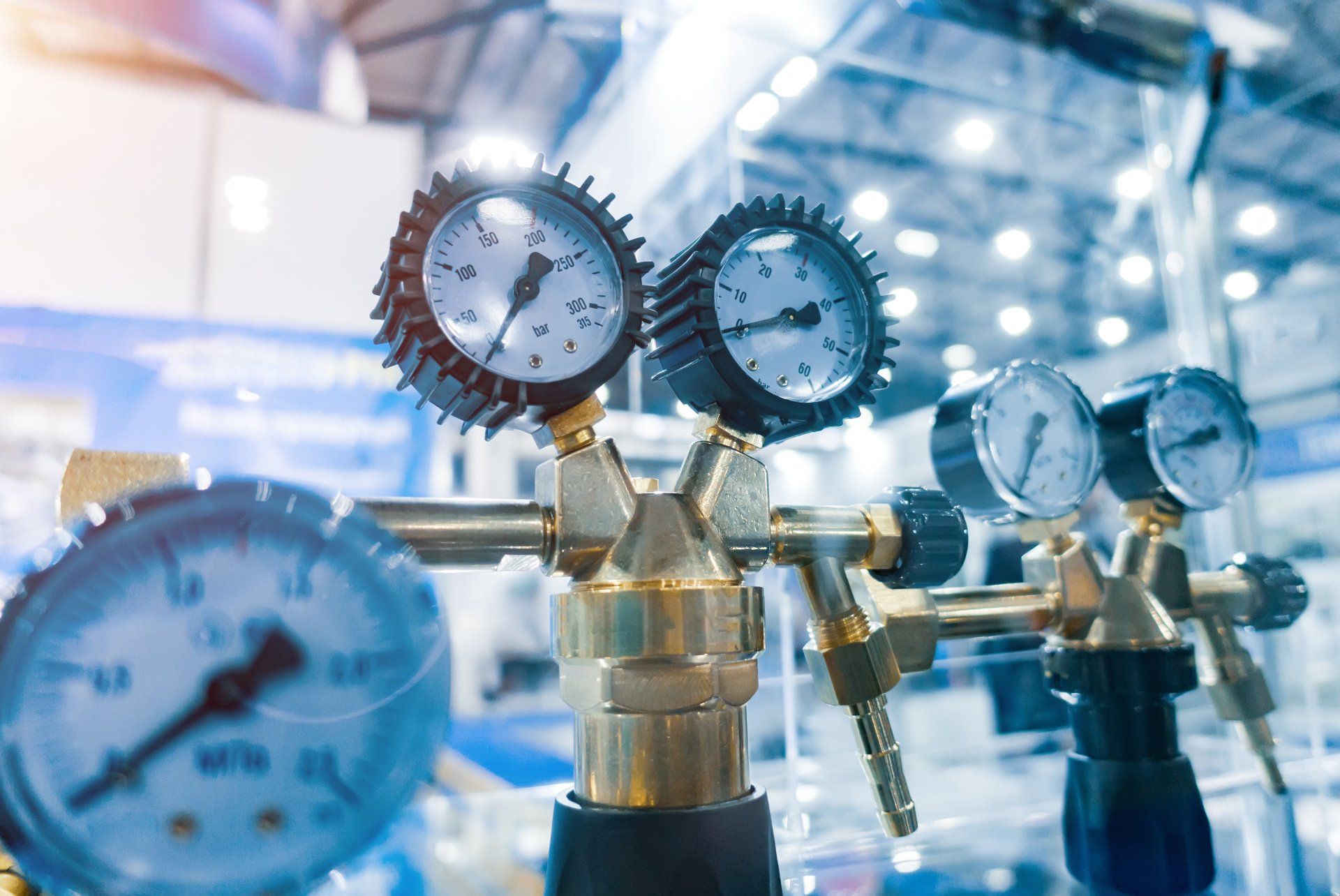 A bunch of pressure gauges are sitting on top of each other on a table.