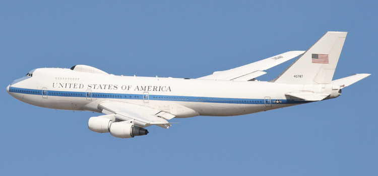 A united states of america airplane is flying in the sky.