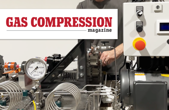 Close up photograph of man's hands working with compressor machinery