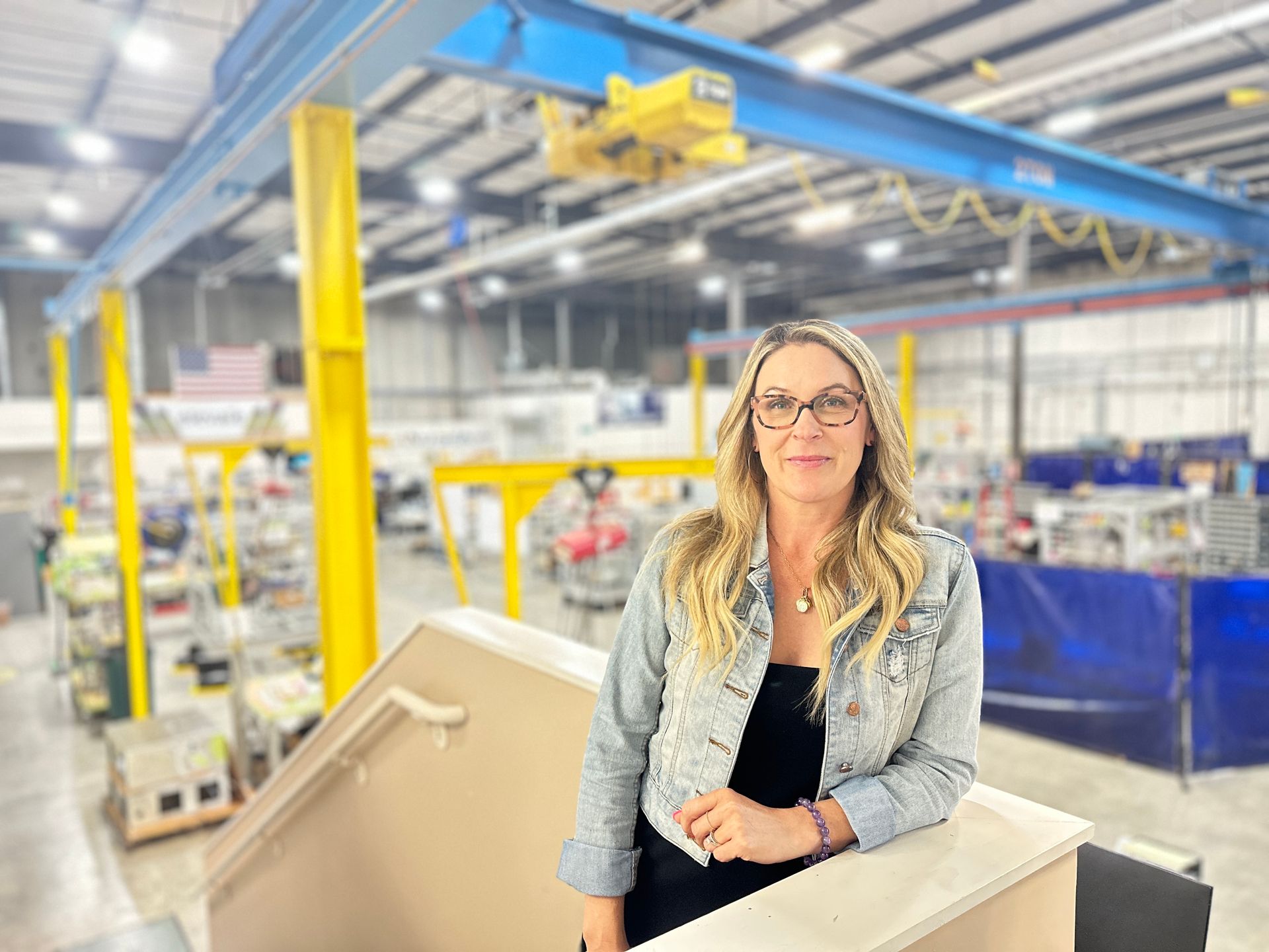 Portrait of RIX President and CEO, Dana Otterson James with Manufacturing plant in the background.