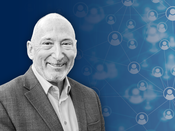 A headshot photo of Marty Ellner on a Navy blue graphic background