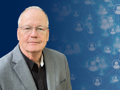 A headshot photo of Michael McNulty on Navy Blue graphic background