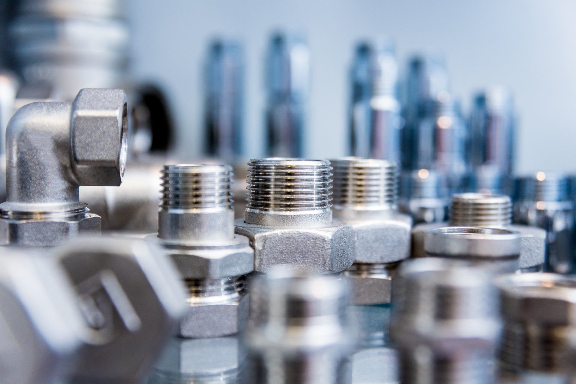 A close up of a bunch of metal fittings on a table.