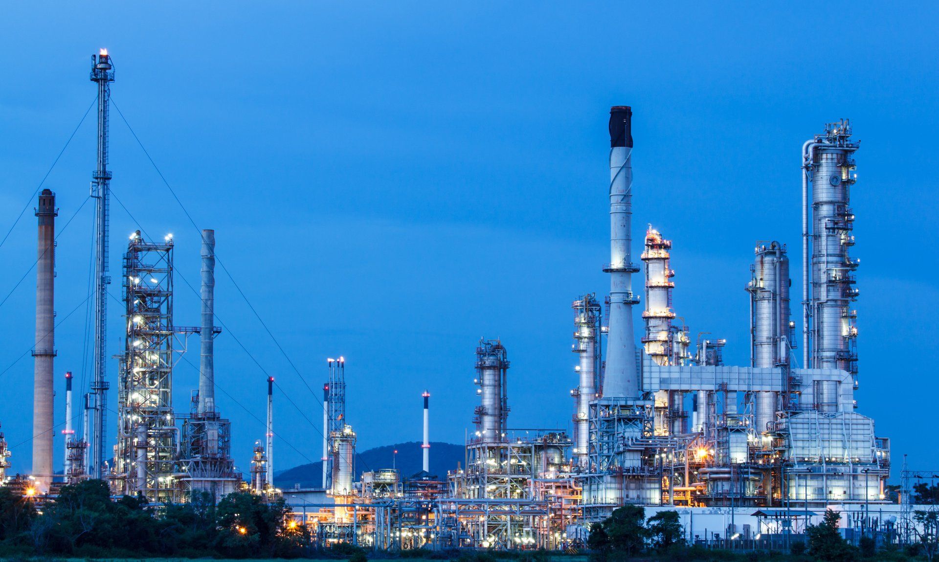 A large oil refinery is lit up at night.