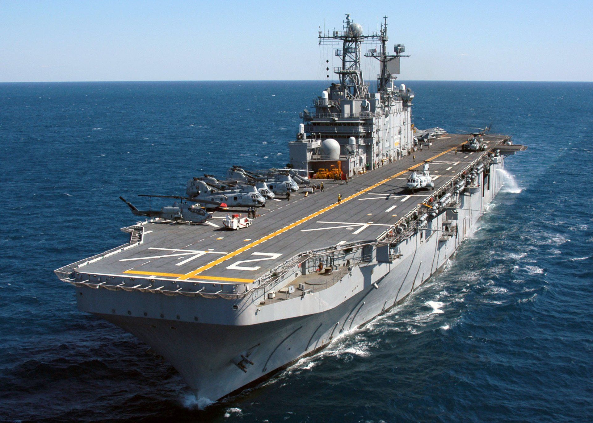 A large military ship is floating in the ocean.