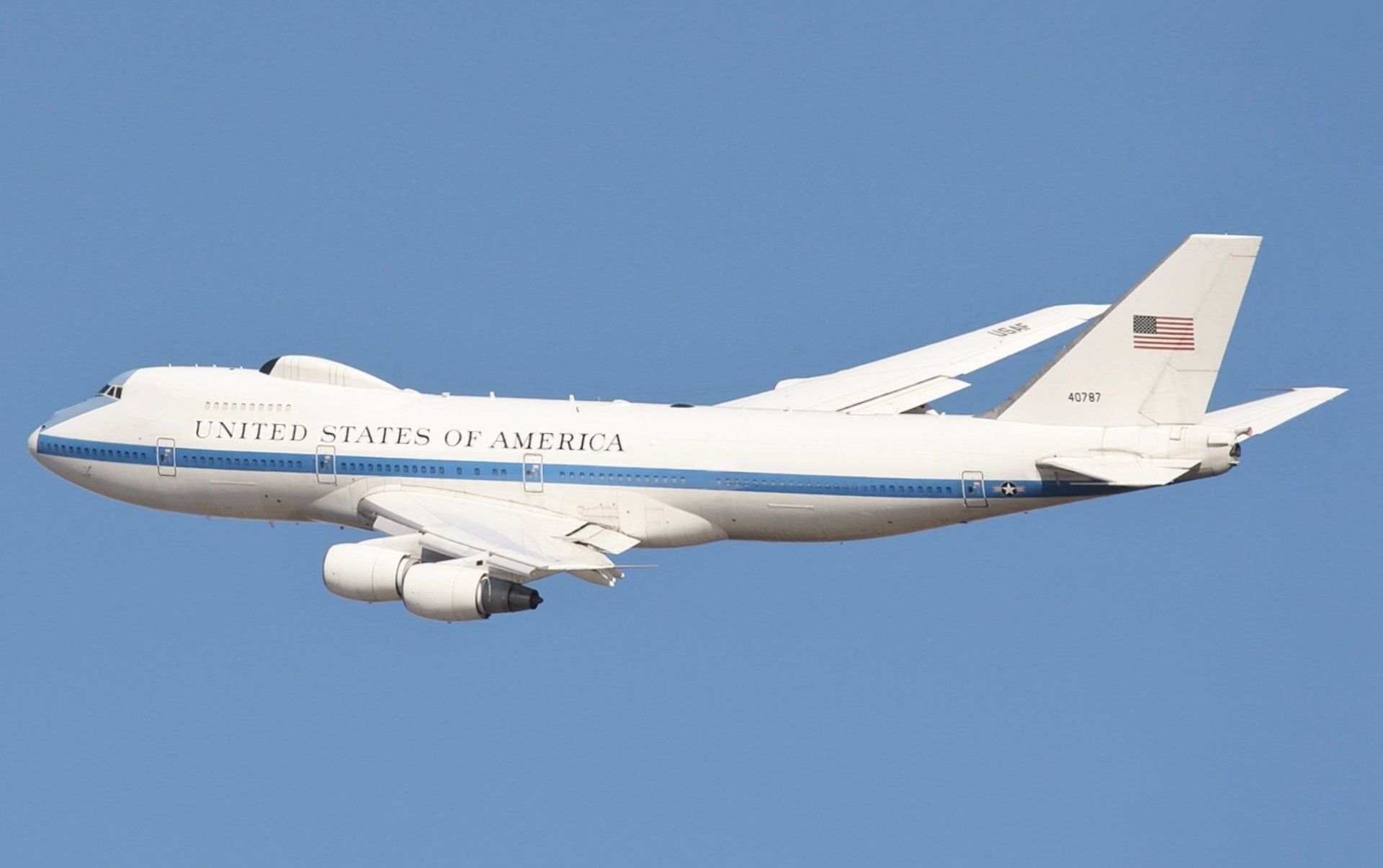 A united states of america airplane is flying in the sky.