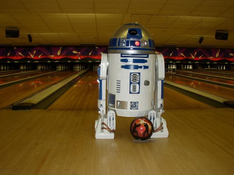 A group of people are playing bowling together in a bowling alley.